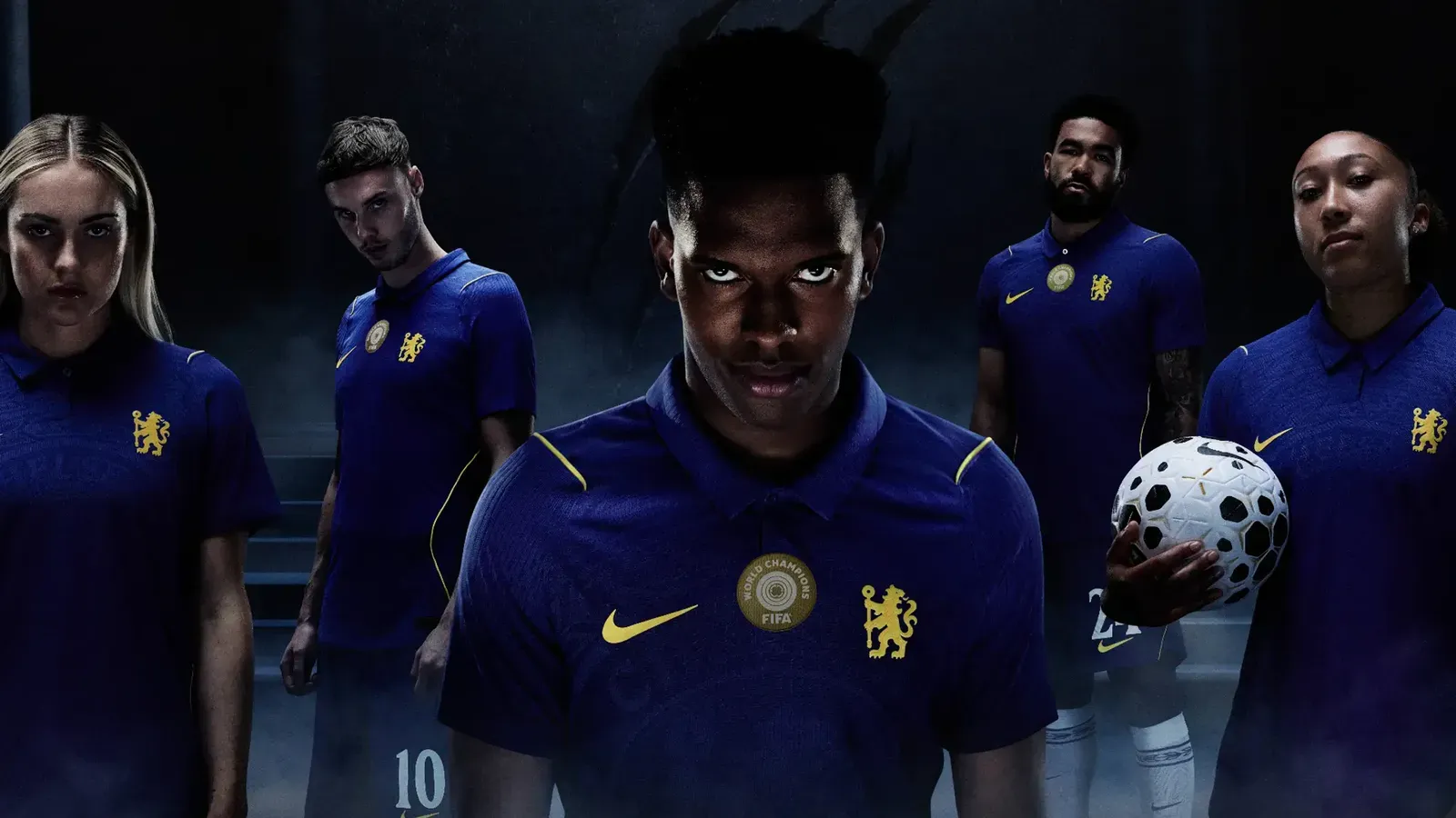 Five footballers in blue kit with a gold lion crest and FIFA World Champions badge, one holding a ball