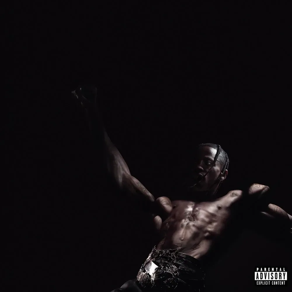 Shirtless rapper raising a fist in near-total darkness on an album cover marked Parental Advisory