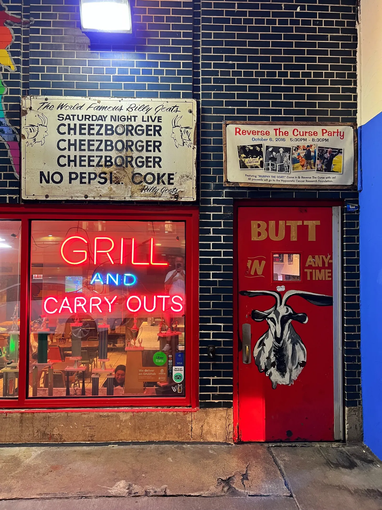 Billy Goat storefront with its Cheezborger, no Pepsi, Coke sign, a neon Grill and Carry Outs window and a goat on the door