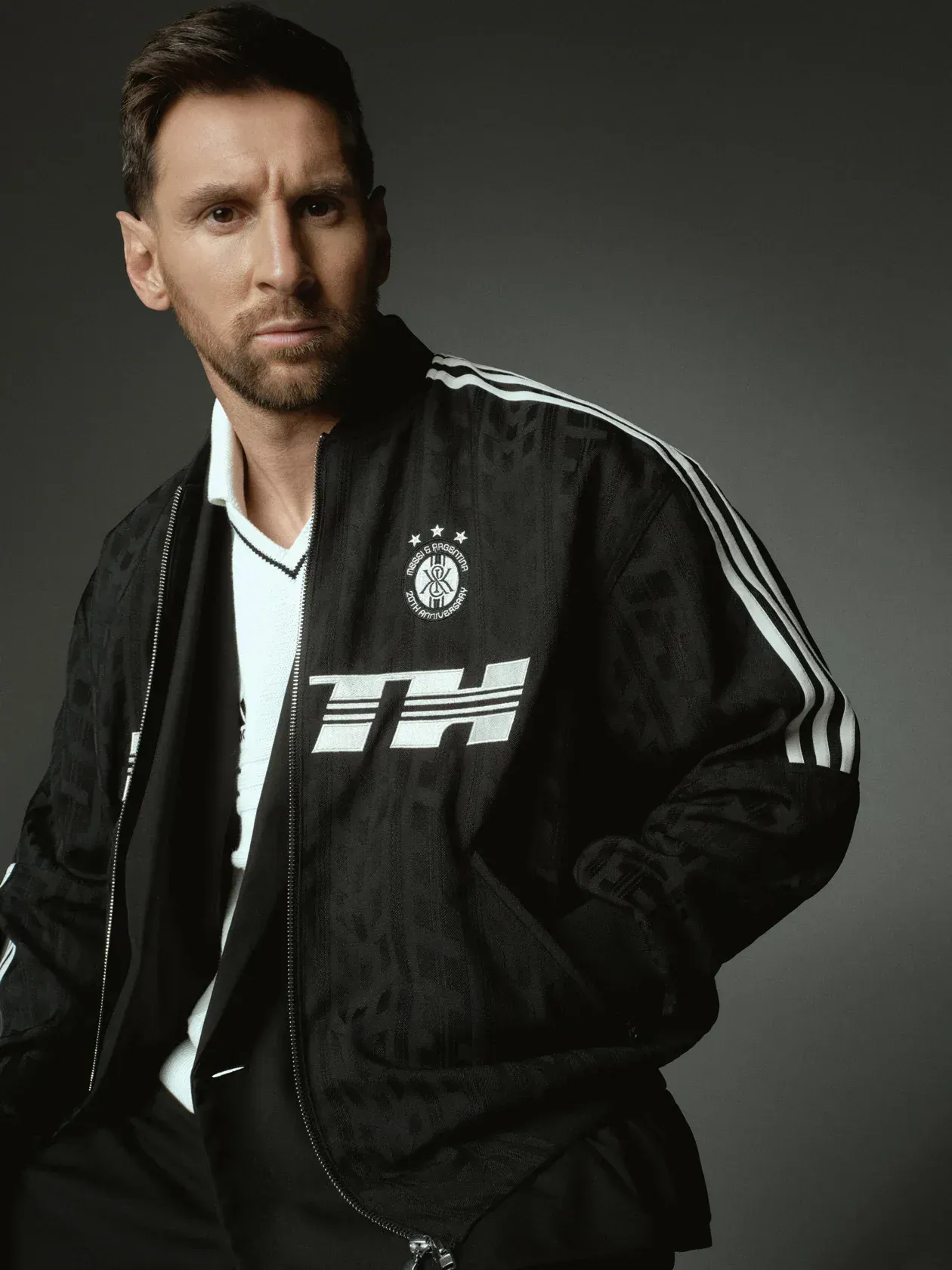 Messi in a black adidas track jacket from the Kith capsule, with a Messi and Argentina 20th anniversary crest