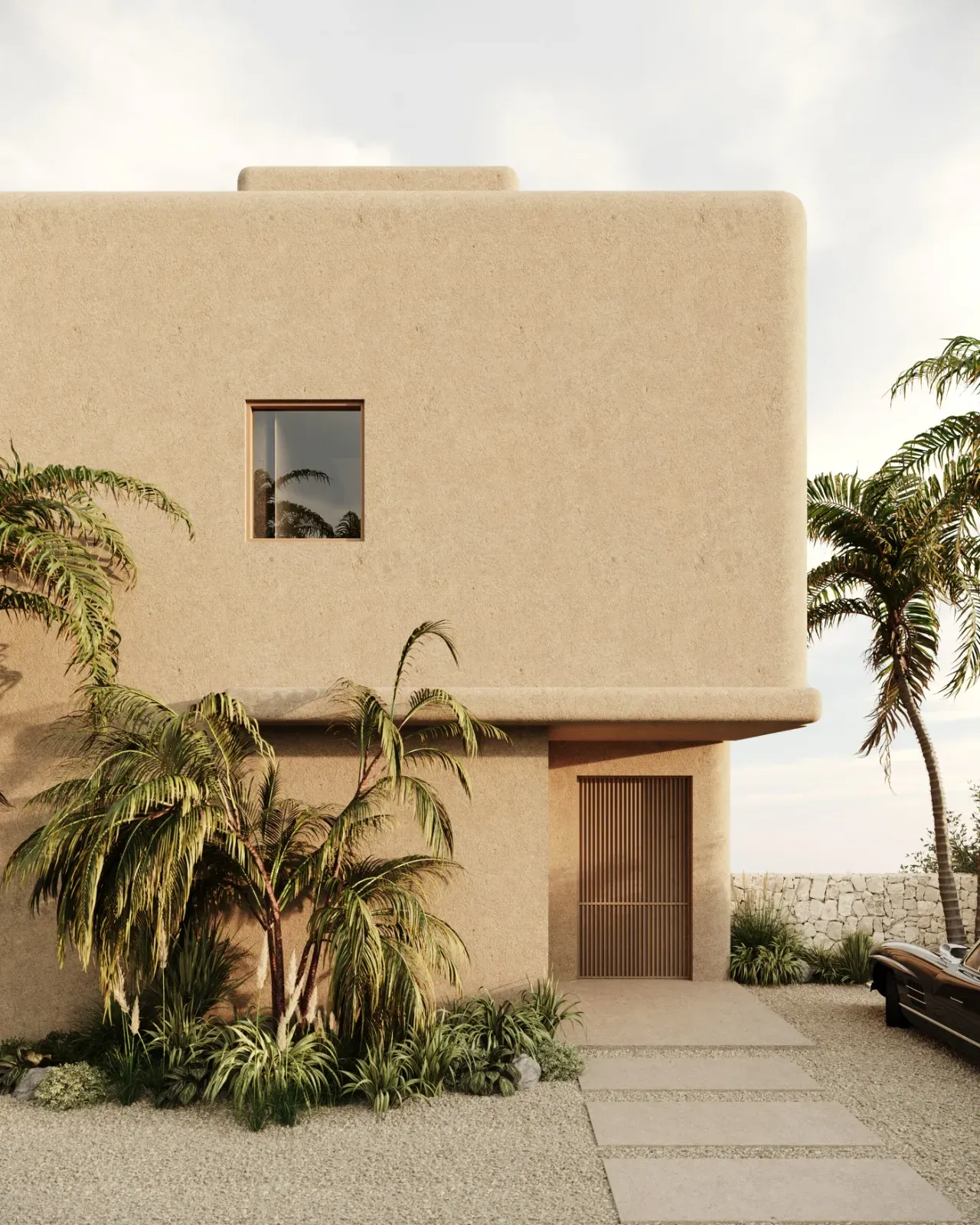 Cubic sand-coloured house with rounded edges, a slatted wooden door, palm trees and a classic car on the gravel