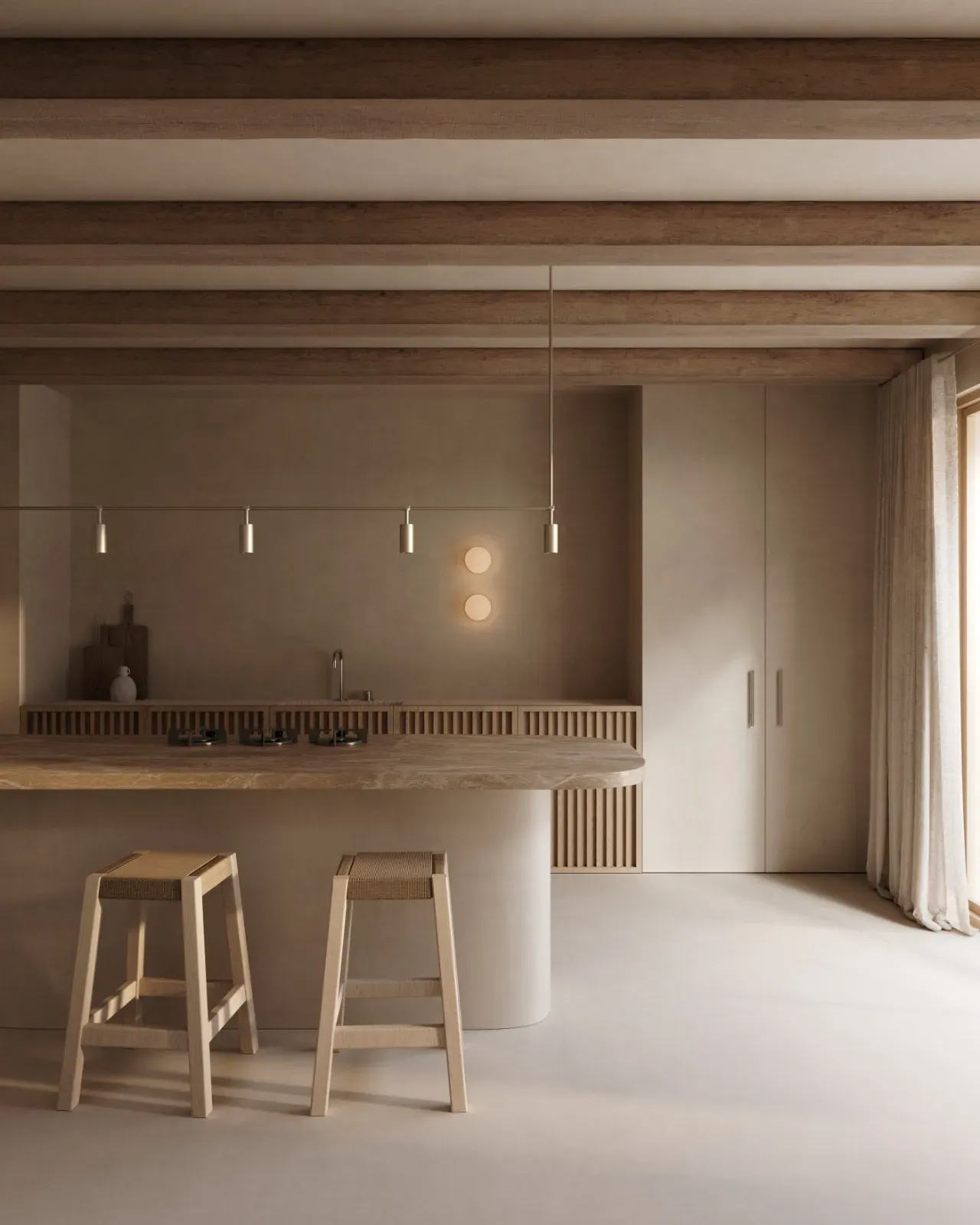 Kitchen with a stone-topped island, two woven-seat stools, slatted oak units, a rail of spotlights and timber beams