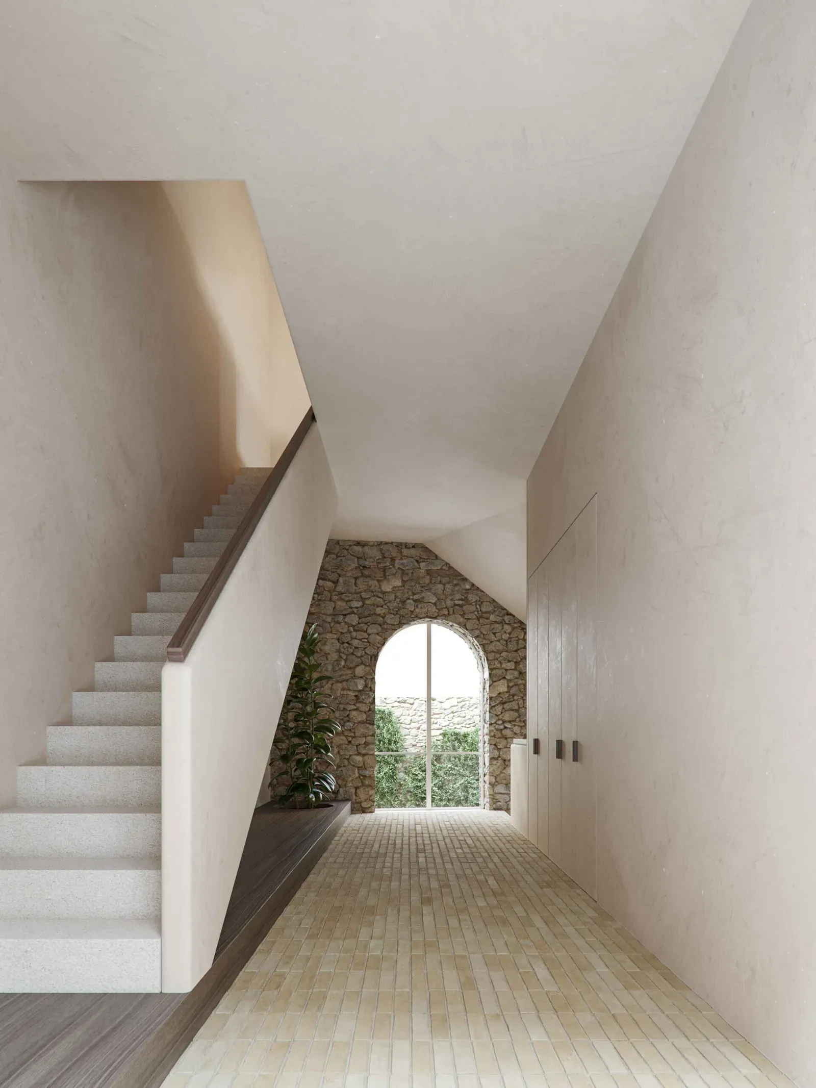 Plastered hallway with a stone staircase, built-in cupboards and an arched window in an old rough stone wall