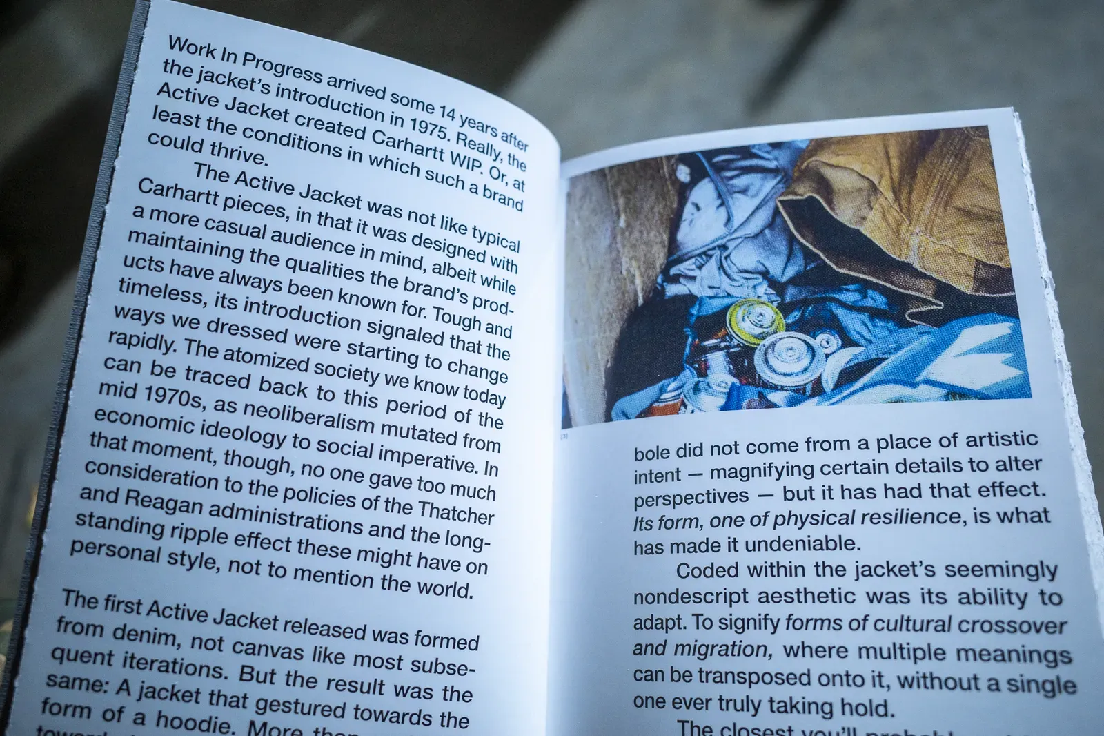 Book pages on the Active Jacket’s 1975 debut and its link to Carhartt WIP, beside a photo of spray paint cans