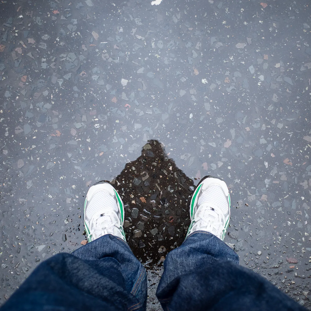 Looking down at my trainers on a wet Paris pavement.