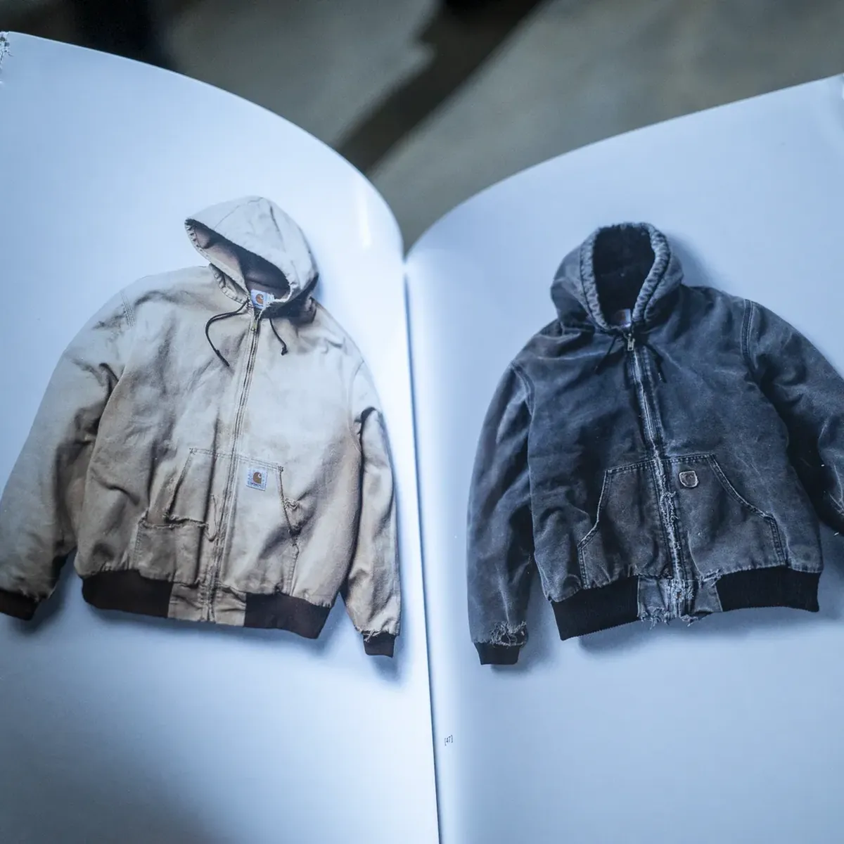 The anniversary book open on two Active Jackets.